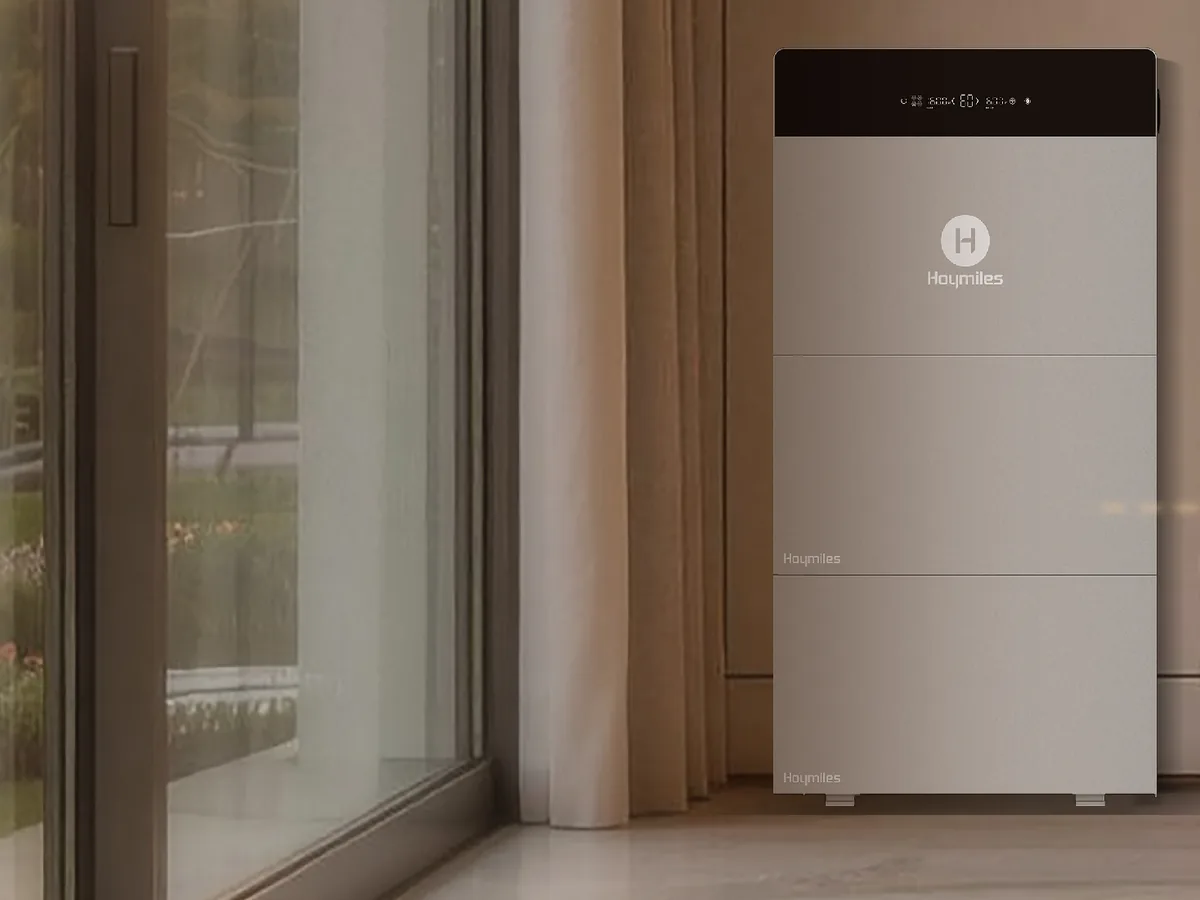 Hoymiles HiBattery 4020 X with expansion packs in a living area next to a floor-to-ceiling window front